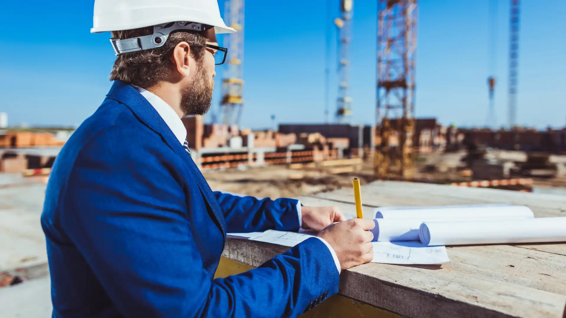 businessman-in-hardhat-and-suit-working-with-build-2024-11-17-19-39-37-utc