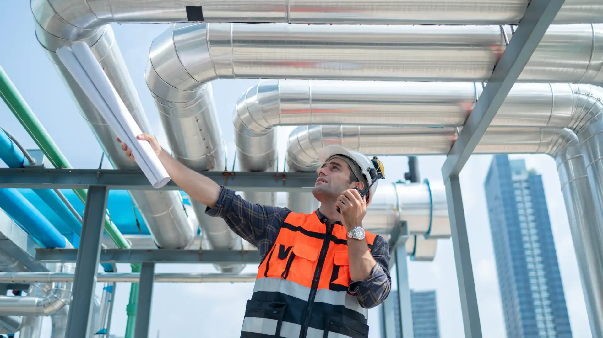 engineer-inspecting-industrial-pipes-on-rooftop-2025-03-08-18-10-02-utc