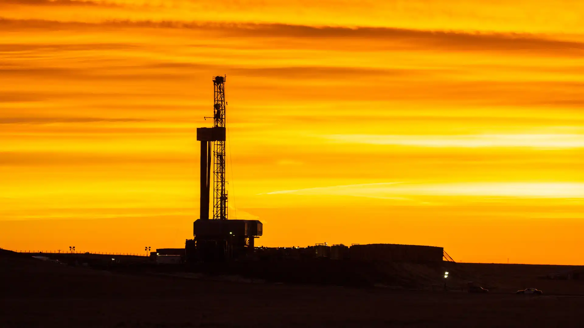 silhouette-of-a-drilling-rig-against-an-orange-sun-2025-02-02-20-08-03-utc