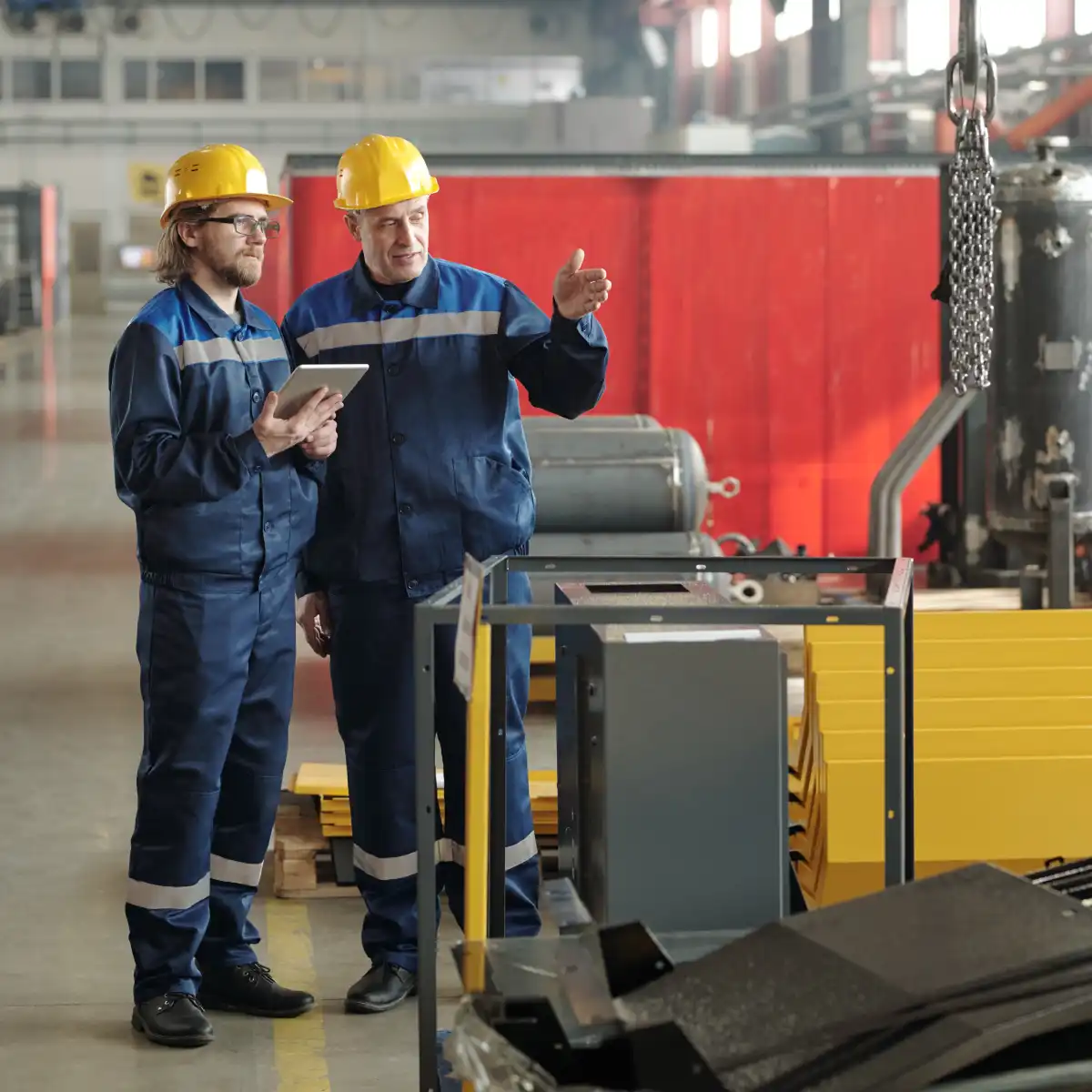 two-engineers-standing-in-large-workshop-or-plant-2025-03-13-10-14-04-utc
